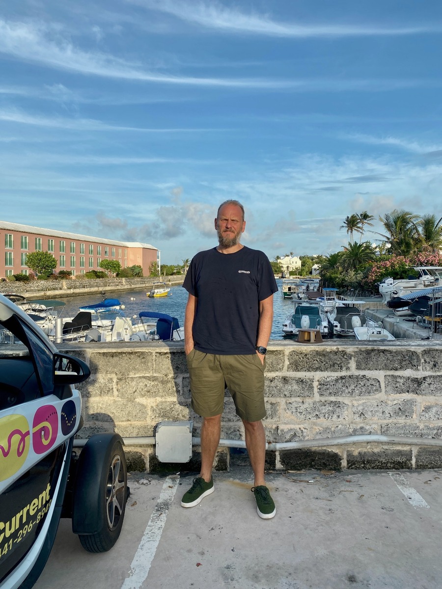Jason standing near a marina sixteen months after diagnosis.